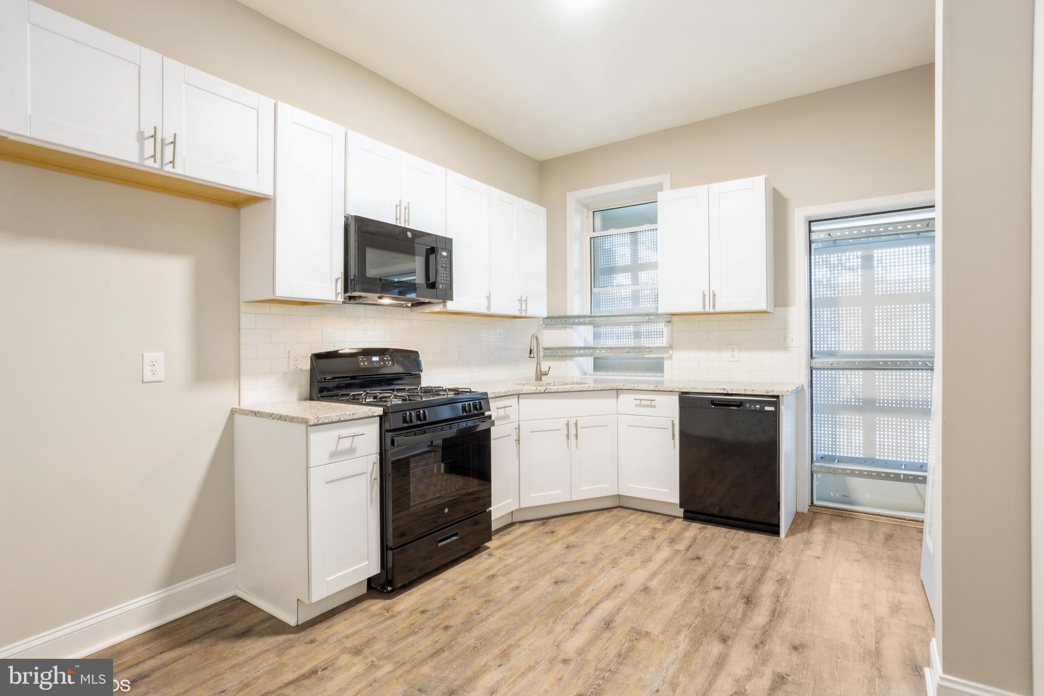 3025 Walbrook Avenue Baltimore, MD 21216 - Photo 7 of 16 a kitchen with a stove top oven and sink