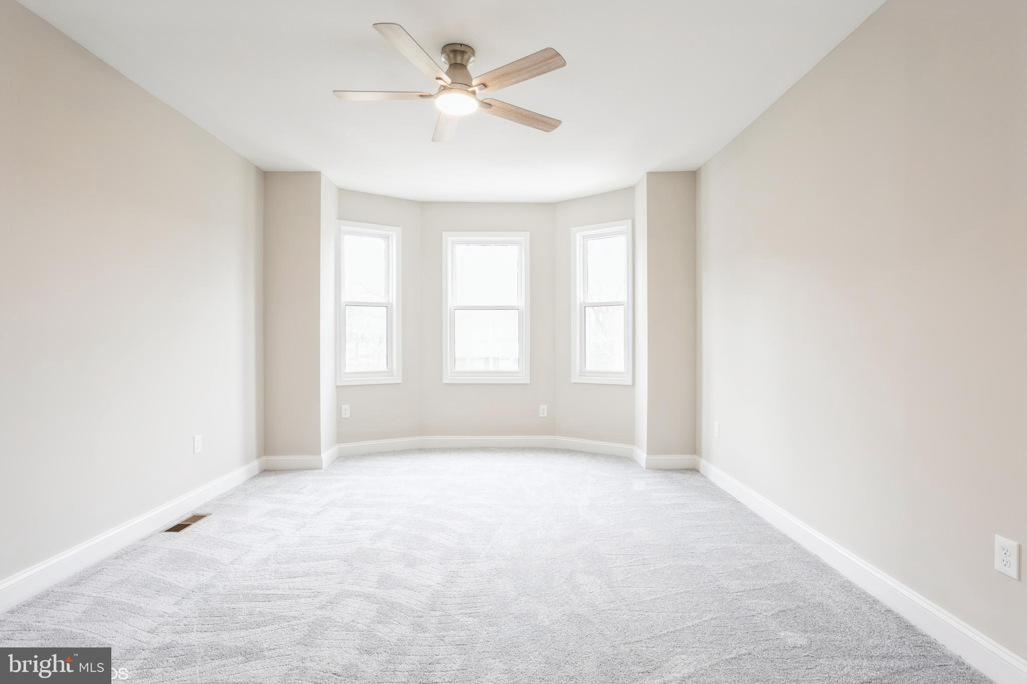 3025 Walbrook Avenue Baltimore, MD 21216 - Photo 9 of 16 a view of an empty room with a window