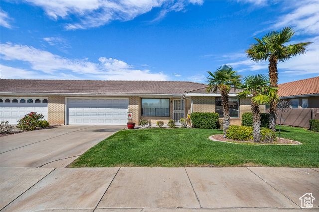 1175 East 900 South St. George, UT 84790 - Photo 1 of 1 Ranch-style house featuring brick siding, a front yard, concrete driveway, and a garage