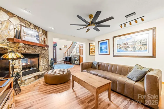a living room with furniture a fireplace and a flat screen tv