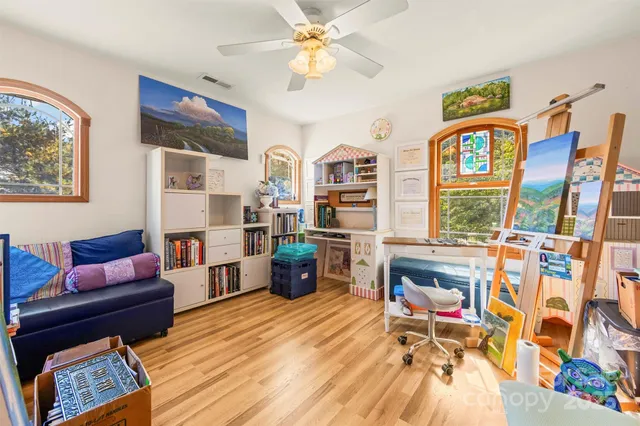 a living room with furniture a rug and a bookshelf