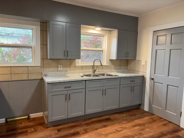 a kitchen with sink cabinets and window