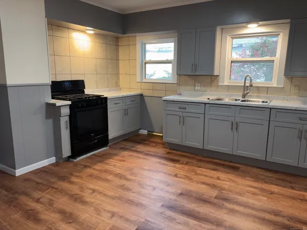 a kitchen with granite countertop a sink and a stove