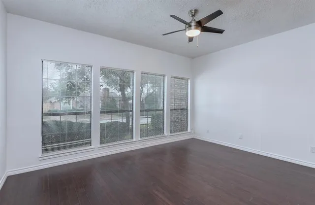 a view of room with window and ceiling fan