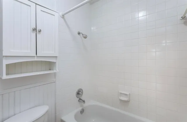 a bathroom with a bathtub and toilet