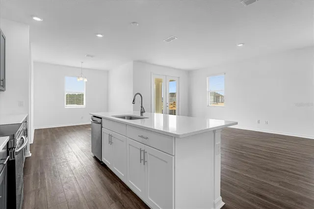 a kitchen with sink and cabinets