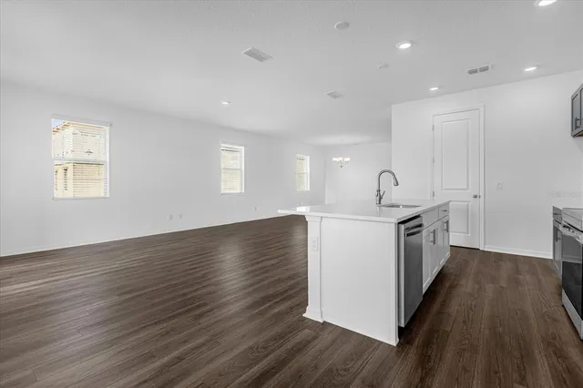 a kitchen with a wooden floor and window