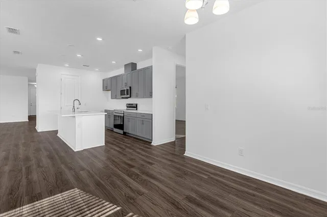 a view of kitchen with wooden floor and electronic appliances