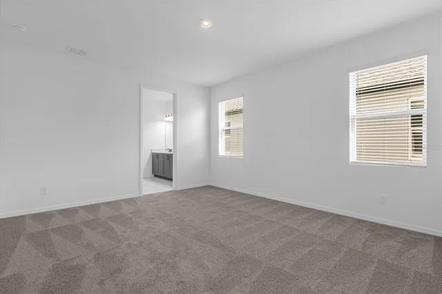 an empty room with windows and closet