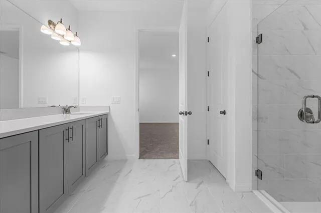 a bathroom with a double vanity sink and mirror