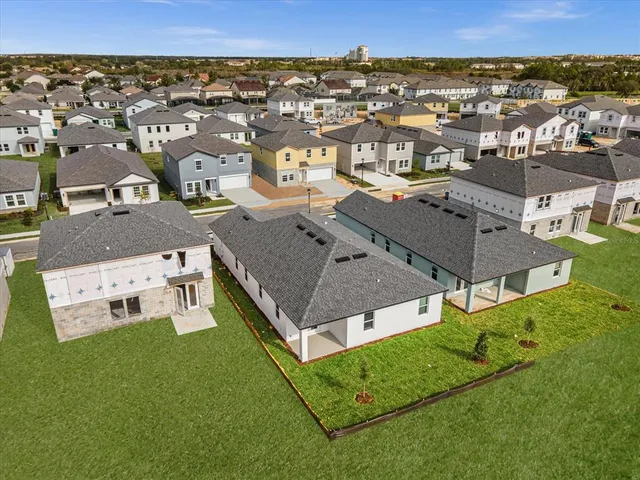 an aerial view of a house with a yard