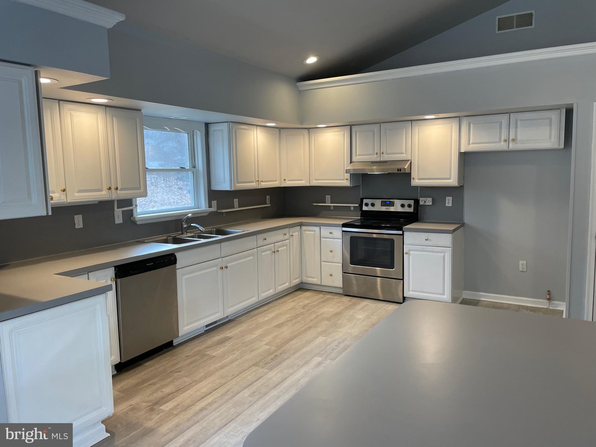 3266 Rosstown Road Wellsville, PA 17365 - Photo 12 of 31 a kitchen with stainless steel appliances a stove sink and cabinets