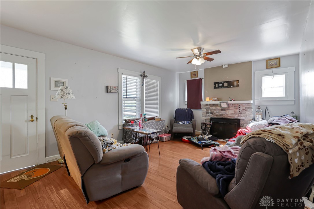 2390 Ridge Road Zanesville, OH 43701 - Photo 10 of 45 This inviting living room features a fireplace, hardwood flooring, and ample natural light.
