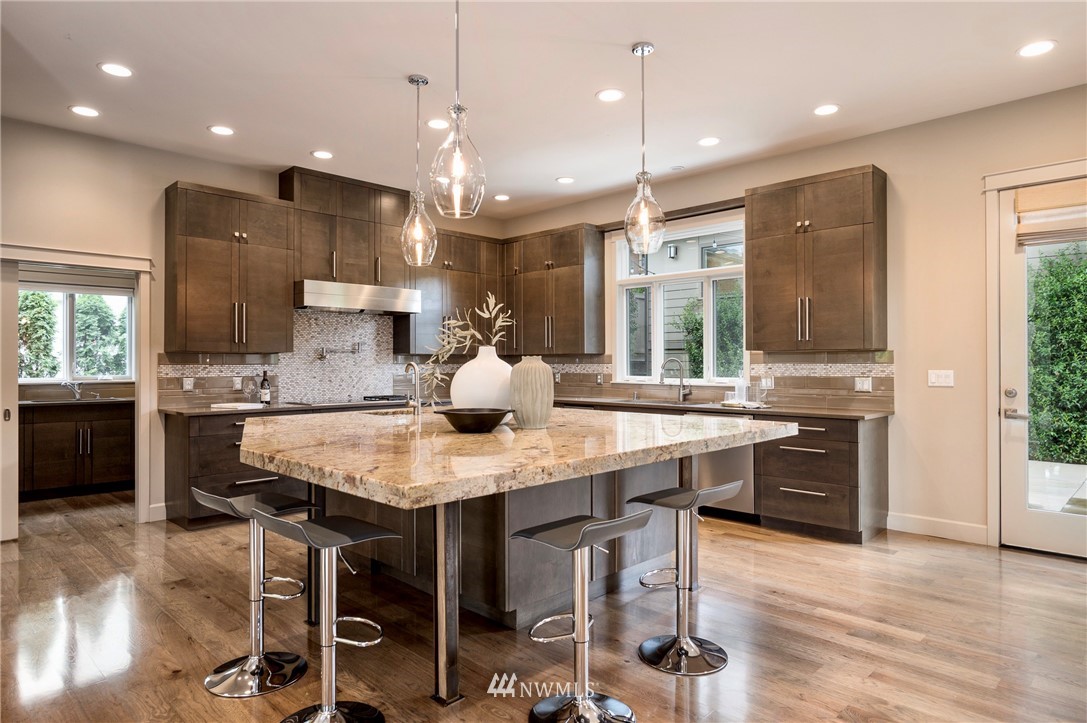 212 5th Avenue West Kirkland, WA 98033 - Photo 13 of 36 a kitchen with a table chairs sink and wooden floor