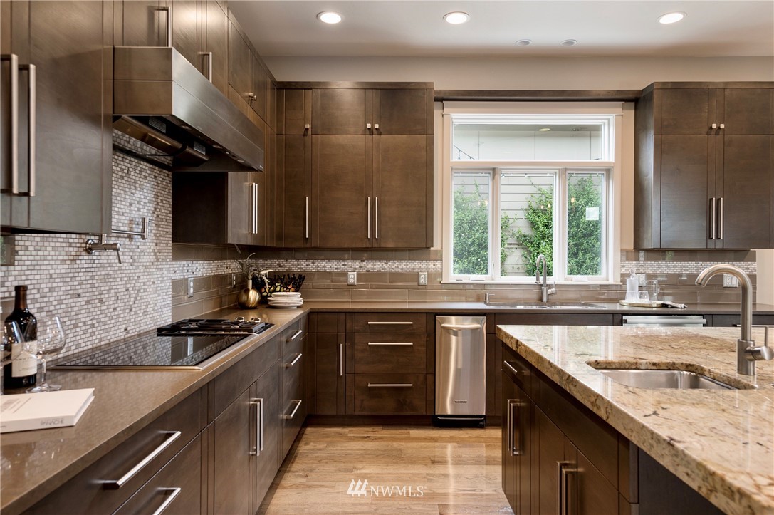 212 5th Avenue West Kirkland, WA 98033 - Photo 14 of 36 a kitchen with a sink stove top oven and cabinets