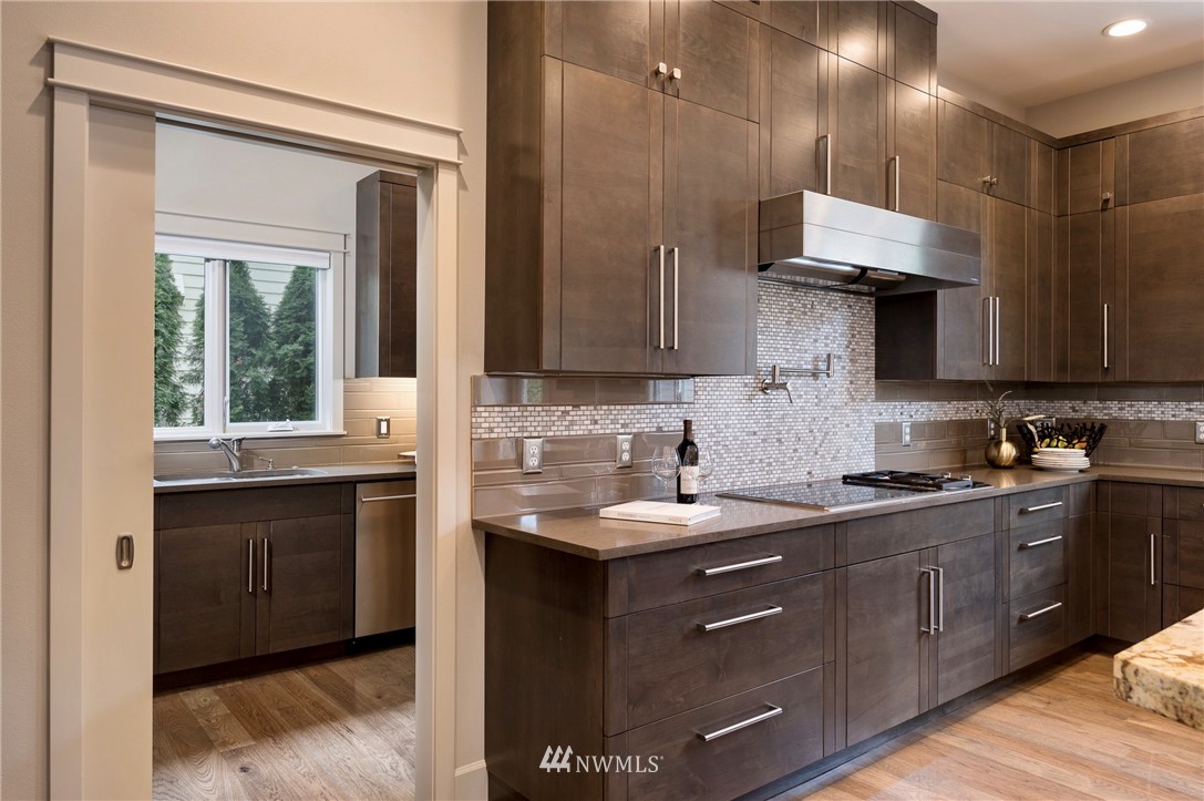 212 5th Avenue West Kirkland, WA 98033 - Photo 16 of 36 a kitchen with a sink a stove and cabinets