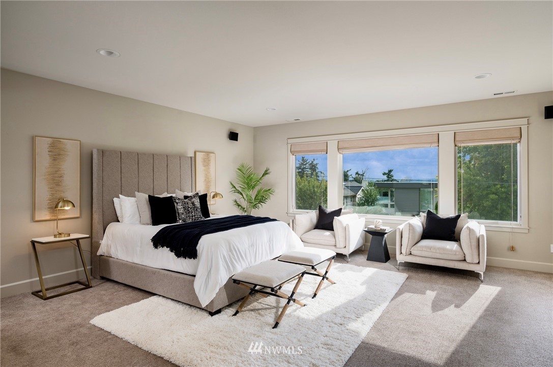 212 5th Avenue West Kirkland, WA 98033 - Photo 29 of 36 a spacious bedroom with a bed and large windows