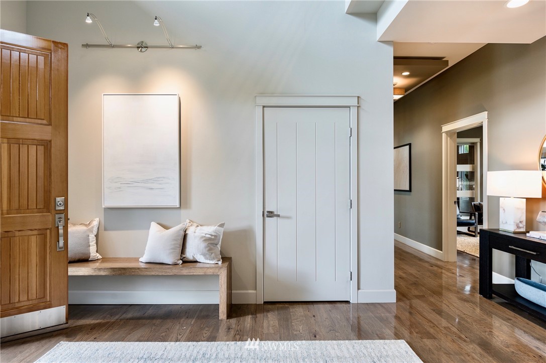212 5th Avenue West Kirkland, WA 98033 - Photo 6 of 36 a view of a hallway with wooden floor and furniture