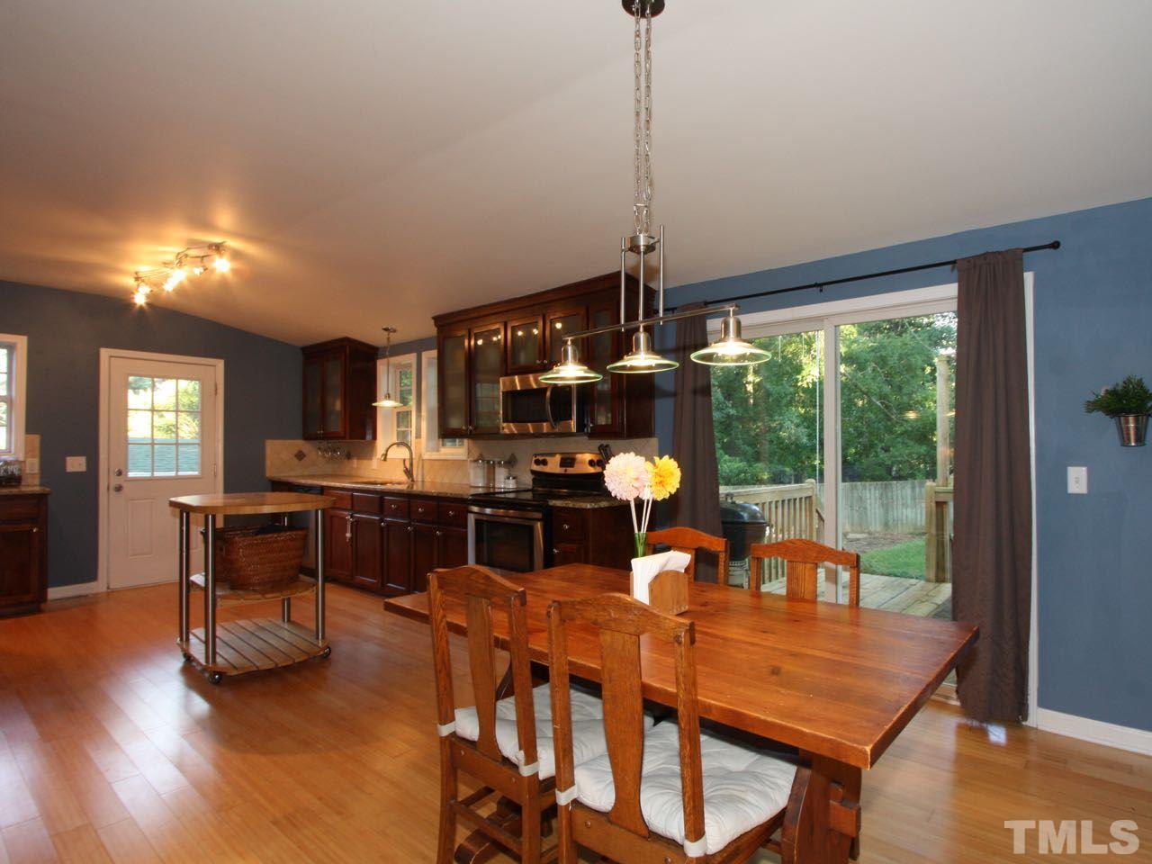 1310 Carpenter Fletcher Road Durham, NC 27713 - Photo 4 of 23 The best of both worlds: a large, bright modern kitchen in a one-level, mid-century house.
