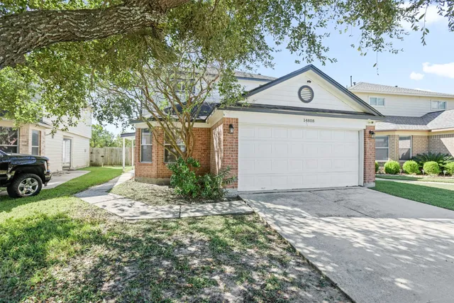 a view of a house with a yard and garage