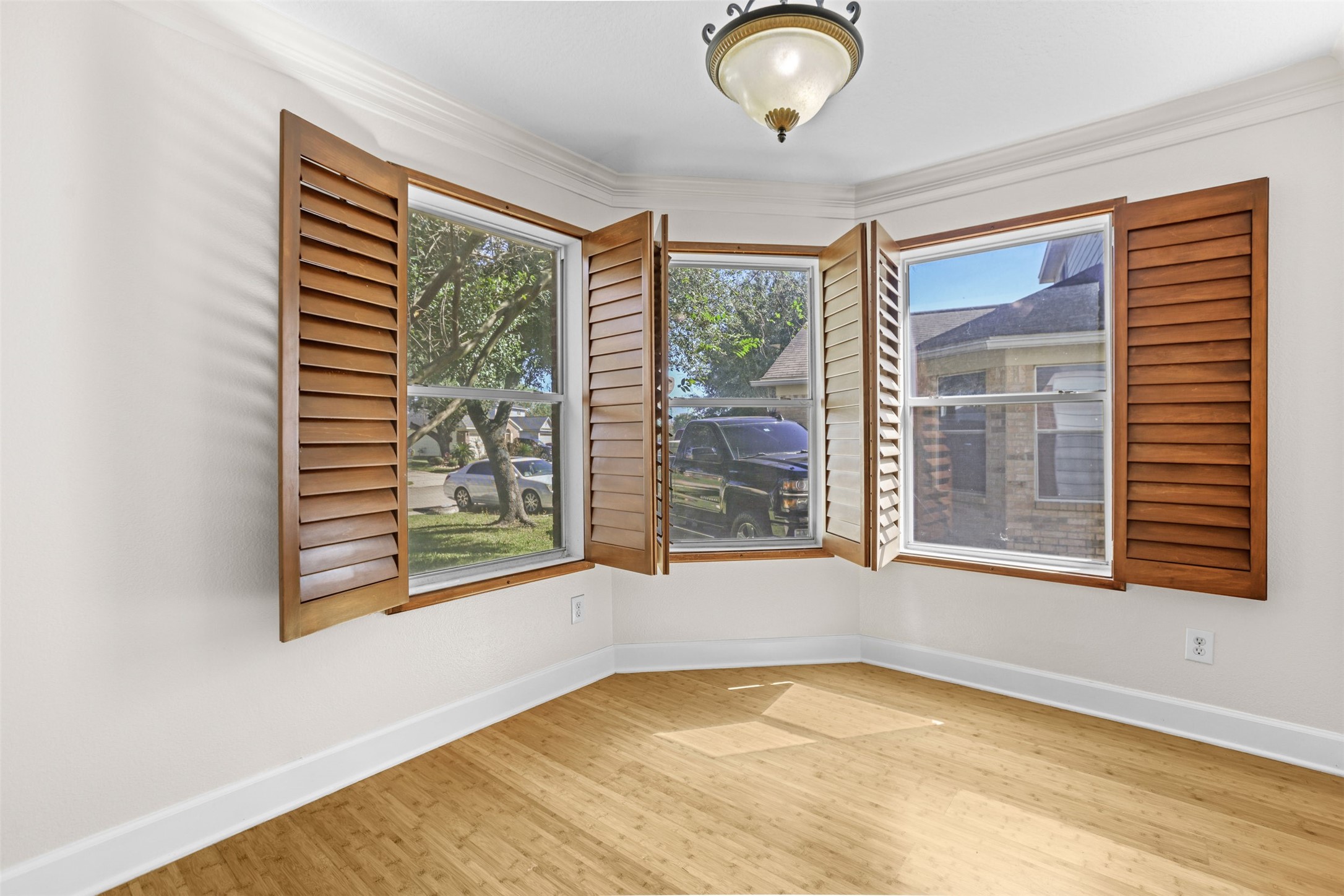 14808 Welbeck Drive Channelview, TX 77530 - Photo 11 of 36 a view of an empty room with a window and wooden floor