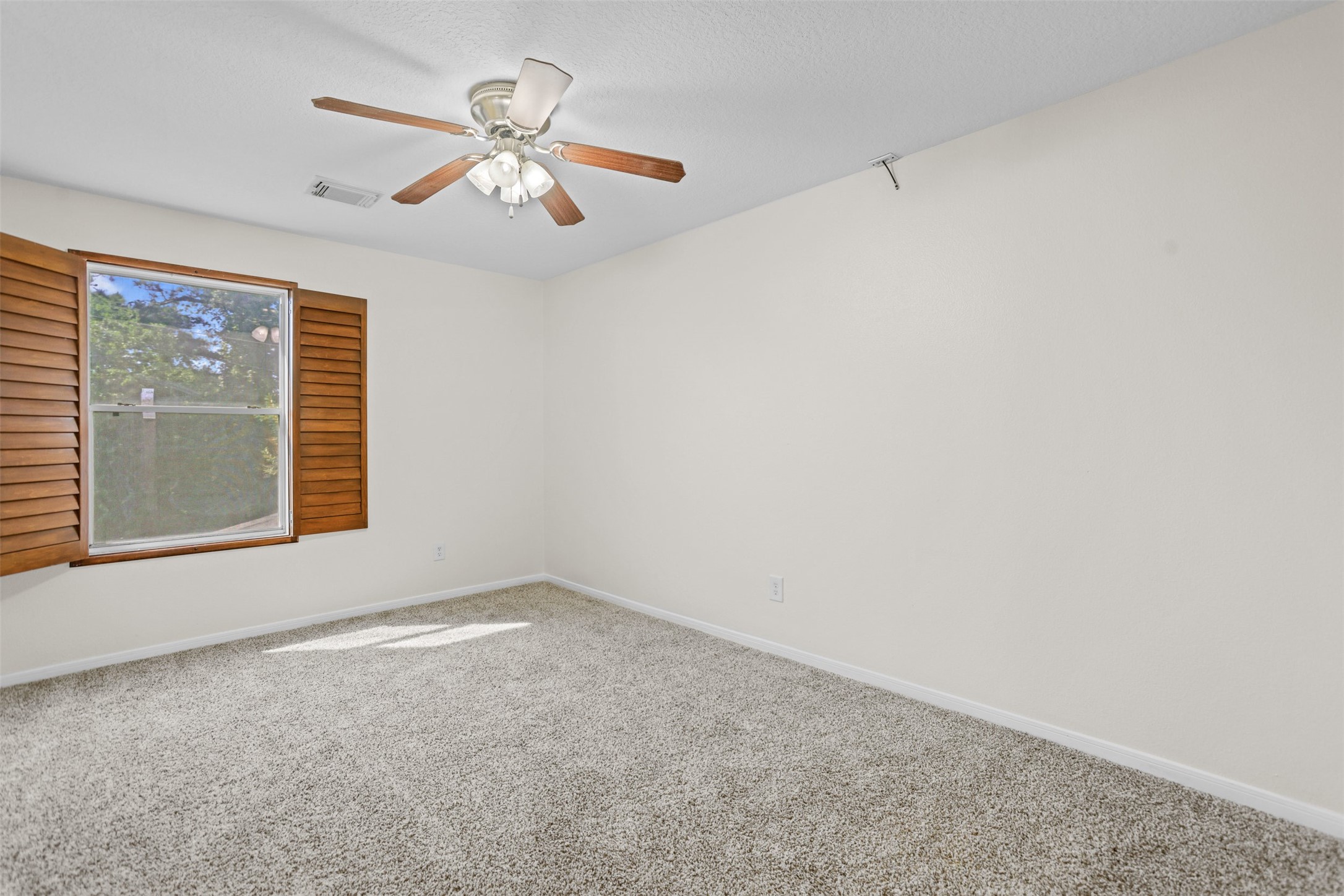 14808 Welbeck Drive Channelview, TX 77530 - Photo 14 of 36 an empty room with a window and a ceiling fan