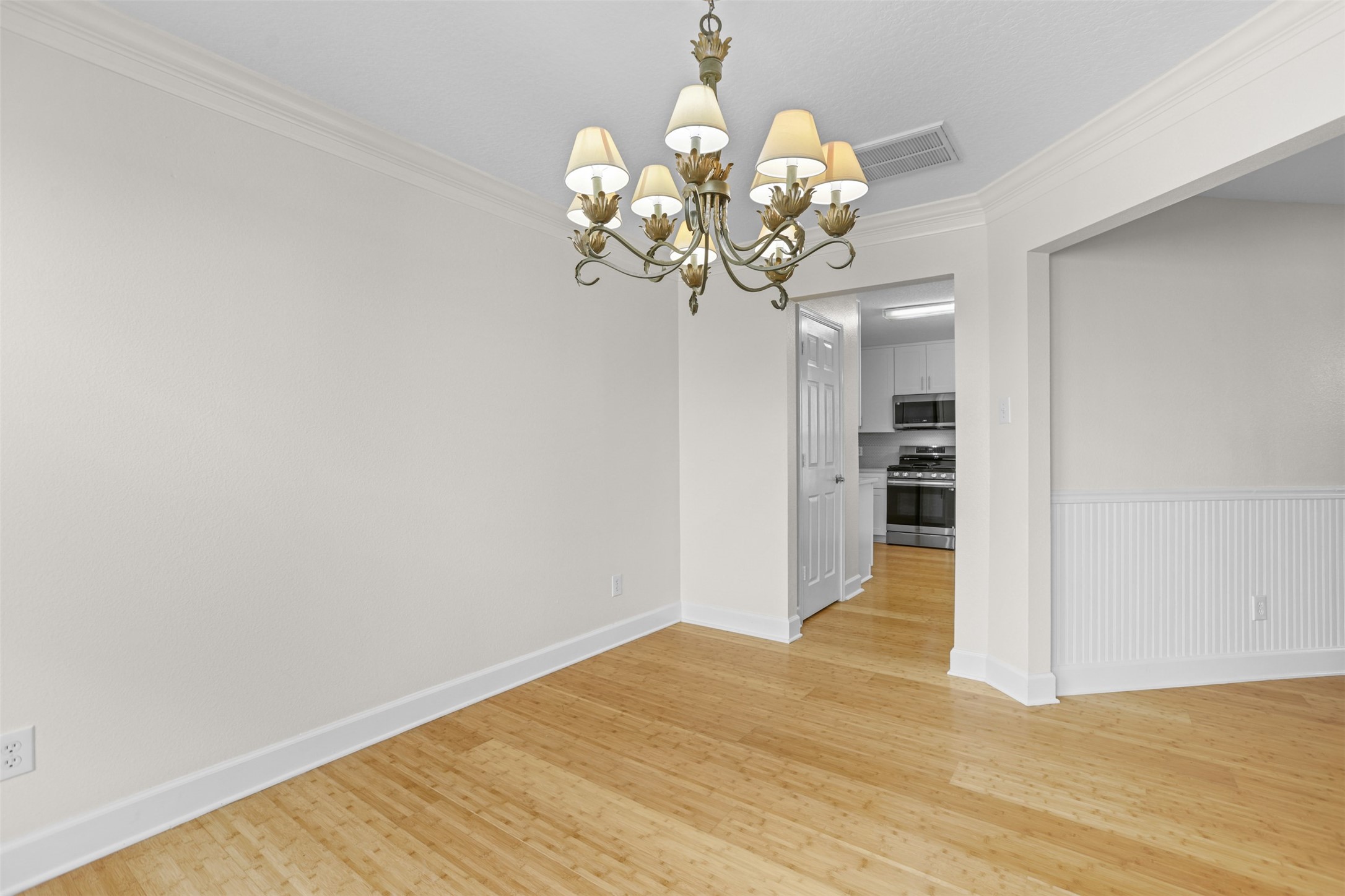 14808 Welbeck Drive Channelview, TX 77530 - Photo 19 of 36 a view of a room with wooden floor and chandelier