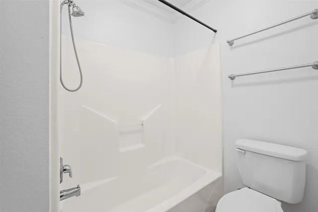 a bathroom with a bath tub with a toilet next to a shower