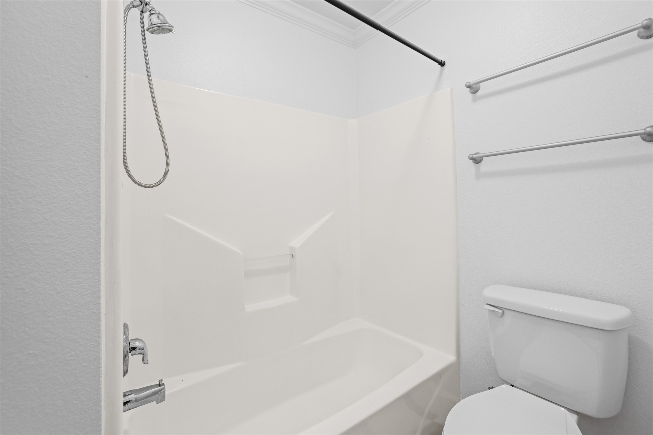 14808 Welbeck Drive Channelview, TX 77530 - Photo 21 of 36 a bathroom with a bath tub with a toilet next to a shower