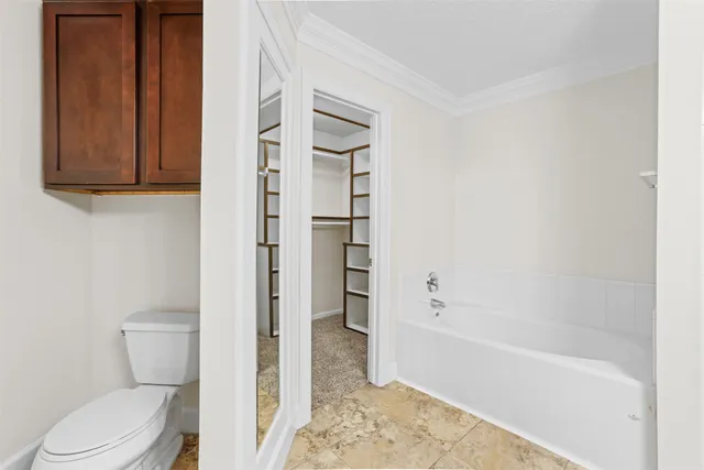 a view of walk in closet with empty racks