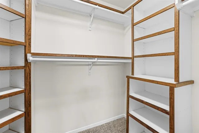 a view of walk in closet with empty room