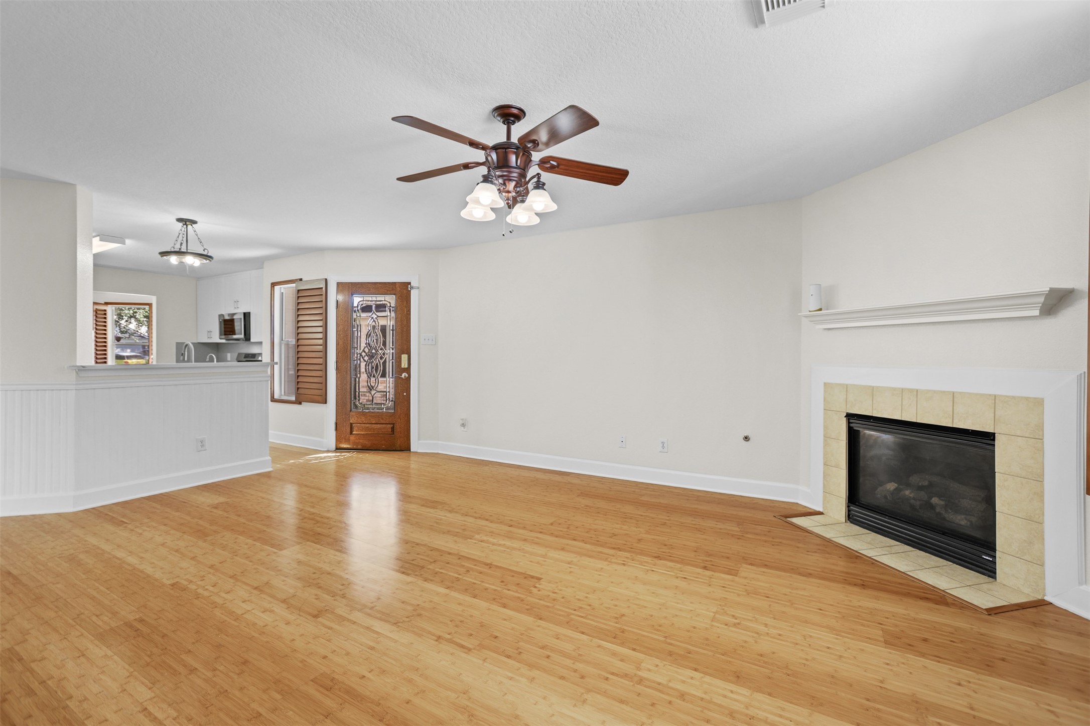 14808 Welbeck Drive Channelview, TX 77530 - Photo 6 of 36 a view of an empty room with a fireplace and a window