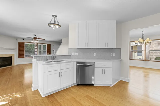 a kitchen with stainless steel appliances granite countertop a stove cabinets and wooden floor