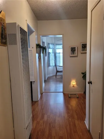 a view of a room with wooden floor and a sink