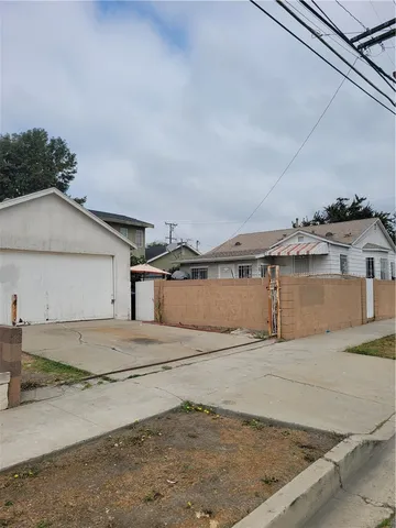 a view of a house with wooden fence