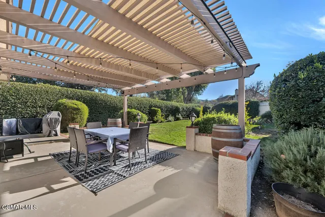 a view of a patio with a table chairs and a backyard