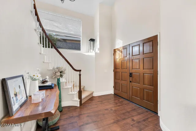 a view of an entryway with wooden floor