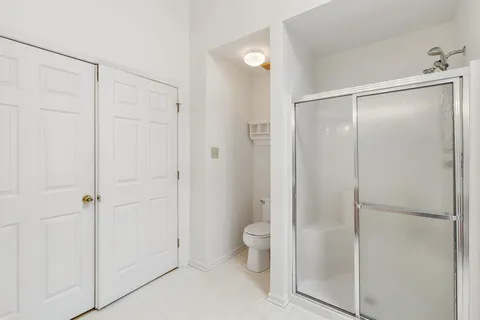 a kitchen with stainless steel appliances granite countertop a stove a sink dishwasher and a refrigerator with wooden floor