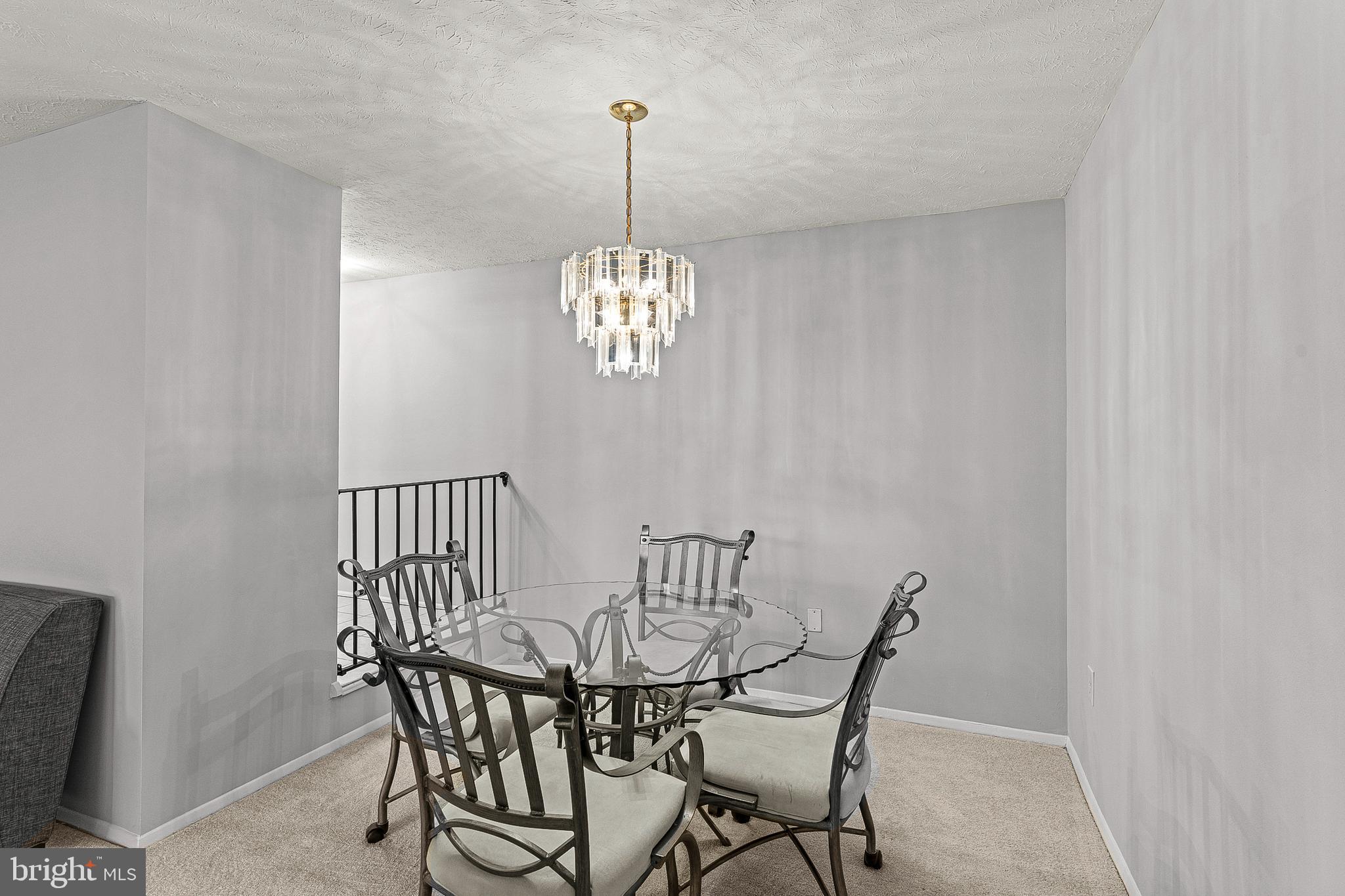 8005 Mandan Road, Unit 302 Greenbelt, MD 20770 - Photo 8 of 22 a view of a dining room with furniture and chandelier