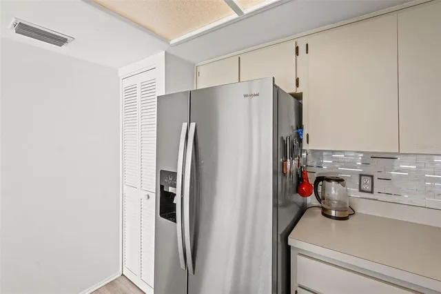 a kitchen with a refrigerator a sink a stove a microwave and island