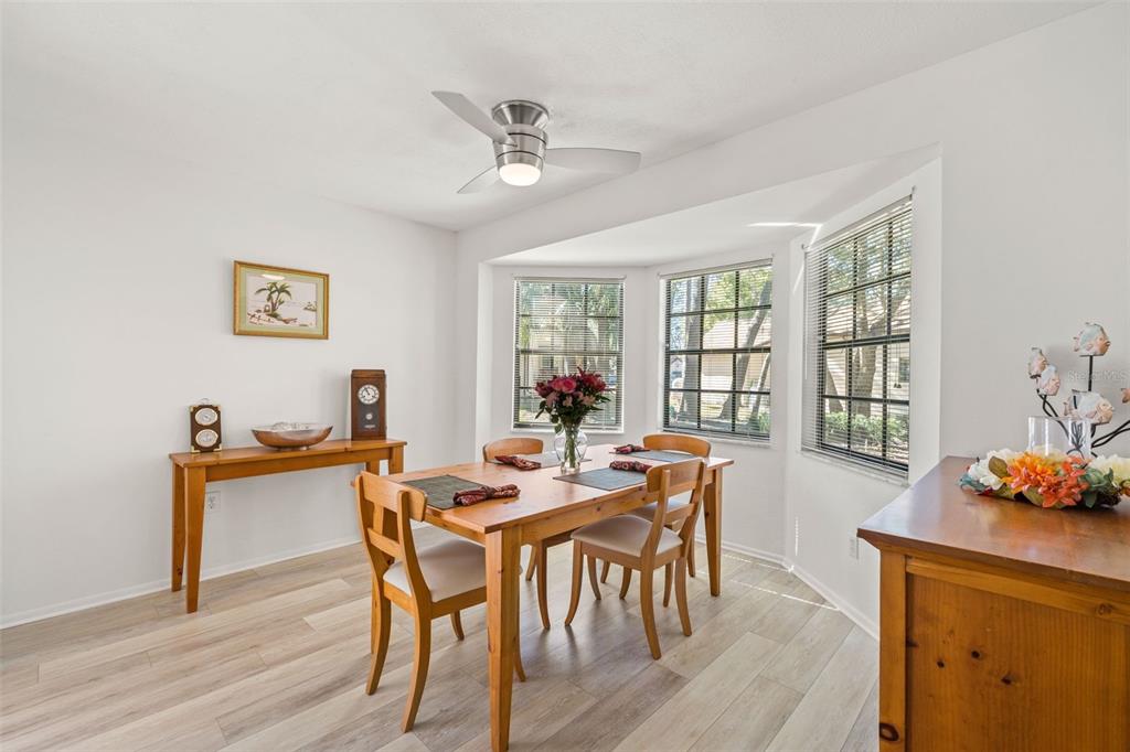 6665 Water Oak Court Spring Hill, FL 34606 - Photo 22 of 64 a view of a dining room with furniture window and wooden floor