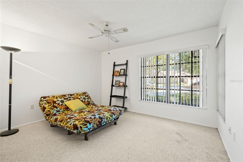 6665 Water Oak Court Spring Hill, FL 34606 - Photo 24 of 64 a bedroom with a bed and a couch