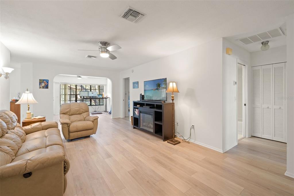 6665 Water Oak Court Spring Hill, FL 34606 - Photo 25 of 64 a living room with furniture and a flat screen tv