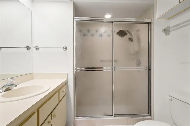 a spacious bedroom with a bed and a dresser