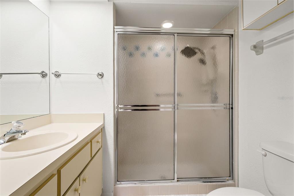 6665 Water Oak Court Spring Hill, FL 34606 - Photo 27 of 64 a bathroom with a shower sink vanity and mirror