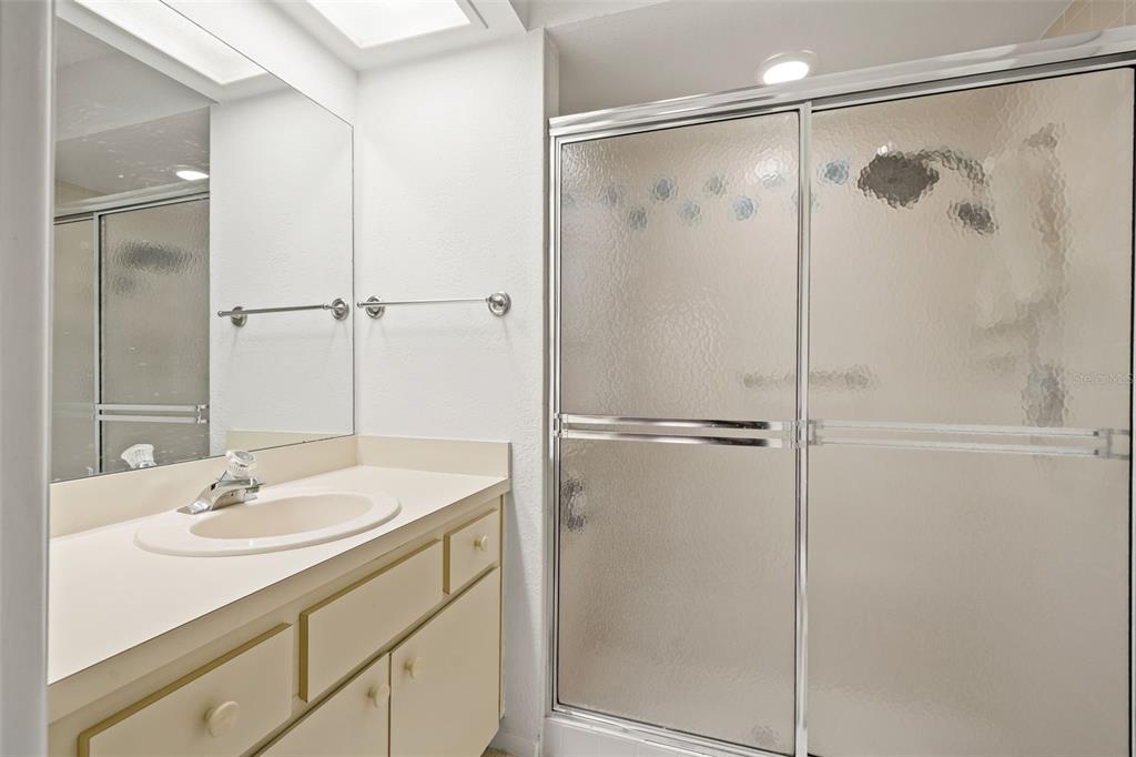 6665 Water Oak Court Spring Hill, FL 34606 - Photo 28 of 64 a bathroom with a shower sink vanity and mirror