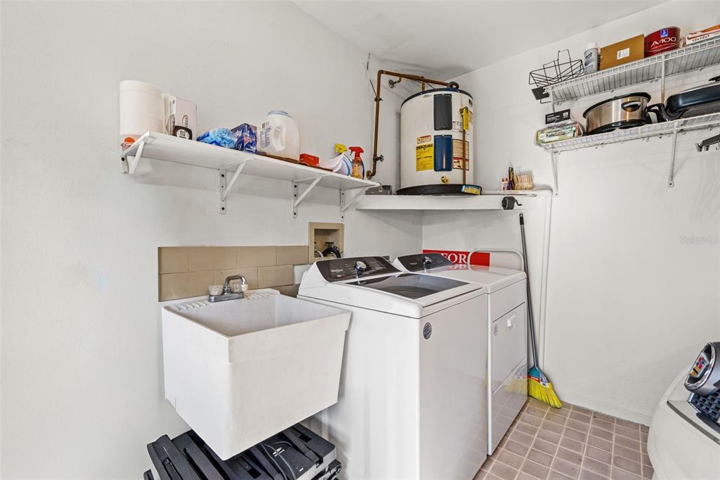 6665 Water Oak Court Spring Hill, FL 34606 - Photo 32 of 64 a utility room with dryer and washer