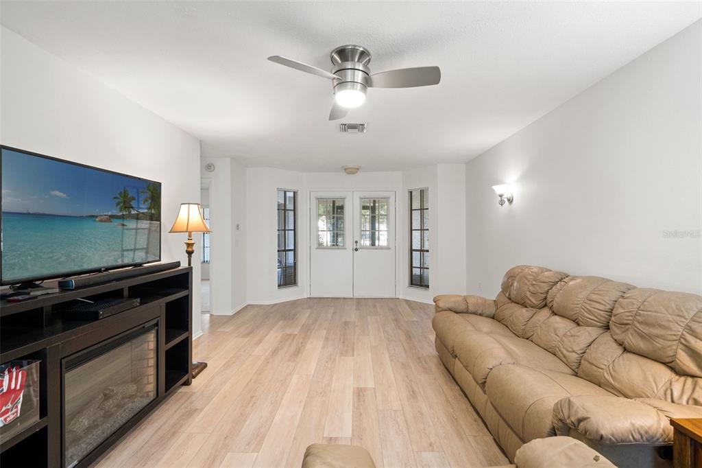 6665 Water Oak Court Spring Hill, FL 34606 - Photo 8 of 64 a living room with furniture and a flat screen tv
