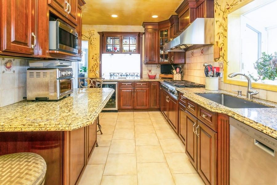 156 80th Street Brooklyn, NY 11209 - Photo 11 of 37 a kitchen with stainless steel appliances granite countertop a stove a sink and a microwave