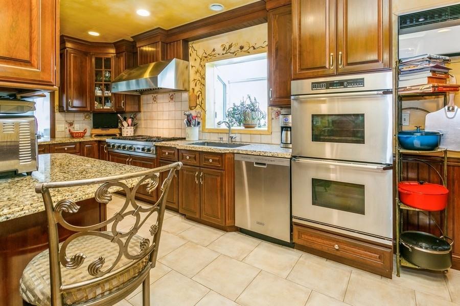 156 80th Street Brooklyn, NY 11209 - Photo 12 of 37 a kitchen with stainless steel appliances granite countertop a stove top oven a sink a counter space and cabinets